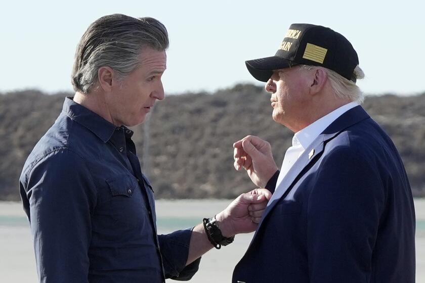 FILE - President Donald Trump talks with California Gov. Gavin Newsom after arriving on Air Force One at Los Angeles International Airport in Los Angeles, Jan. 24, 2025. (AP Photo/Mark Schiefelbein, File)