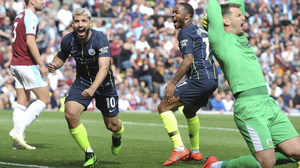 Manchester City's Sergio Aguero, left, celebrates after scoring his side's opening goal during an English Premier League match against Burnley on April 28 at Turf Moor.