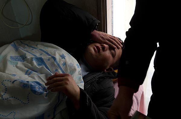 Liu Xiaoping, 30, recovers in his father's office in Xian from injuries he suffered while held captive as slave labor at a brick factory. A recruiter lured Liu, who is mentally disabled, with promise of high wages and perks. Read the full story