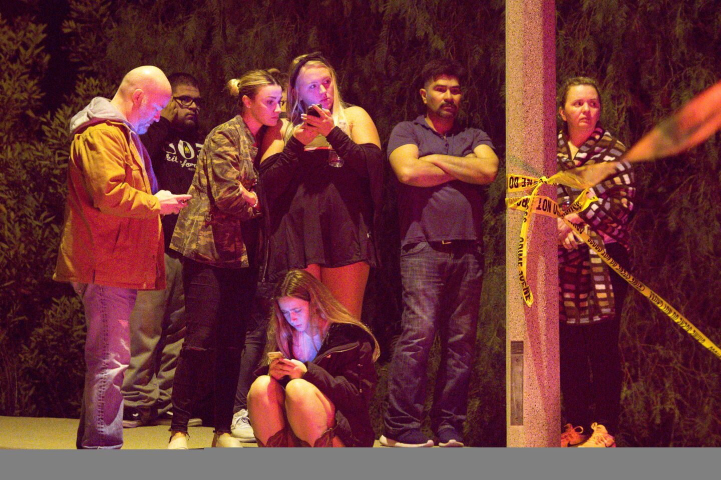 People hug following the shooting.