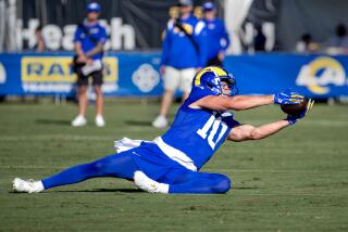 Rams receiver Cooper Kupp makes a diving catch during practice.
