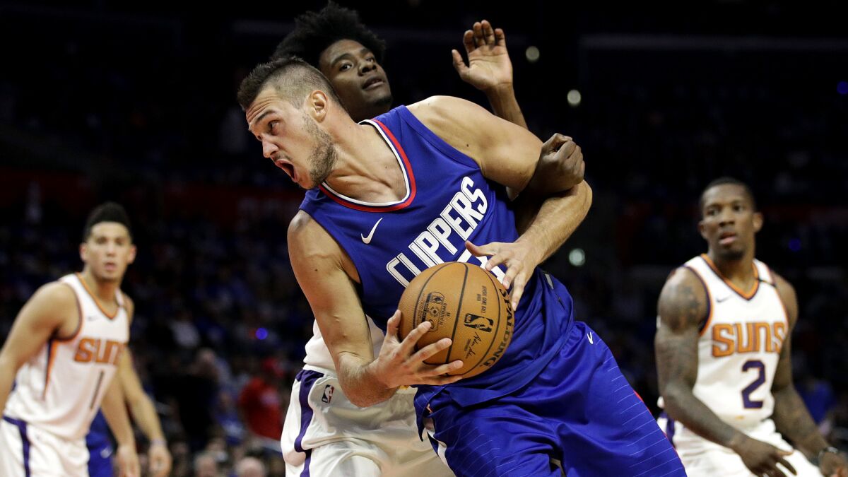 Clippers' Danilo Gallinari is fouled by Phoenix Suns' Josh Jackson during a game Oct. 21 in Los Angeles.