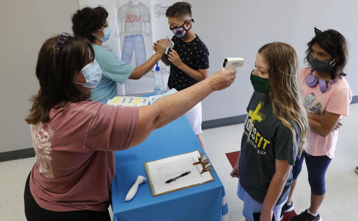 Science teachers check in students before a summer session at a school in Wylie, Texas. 