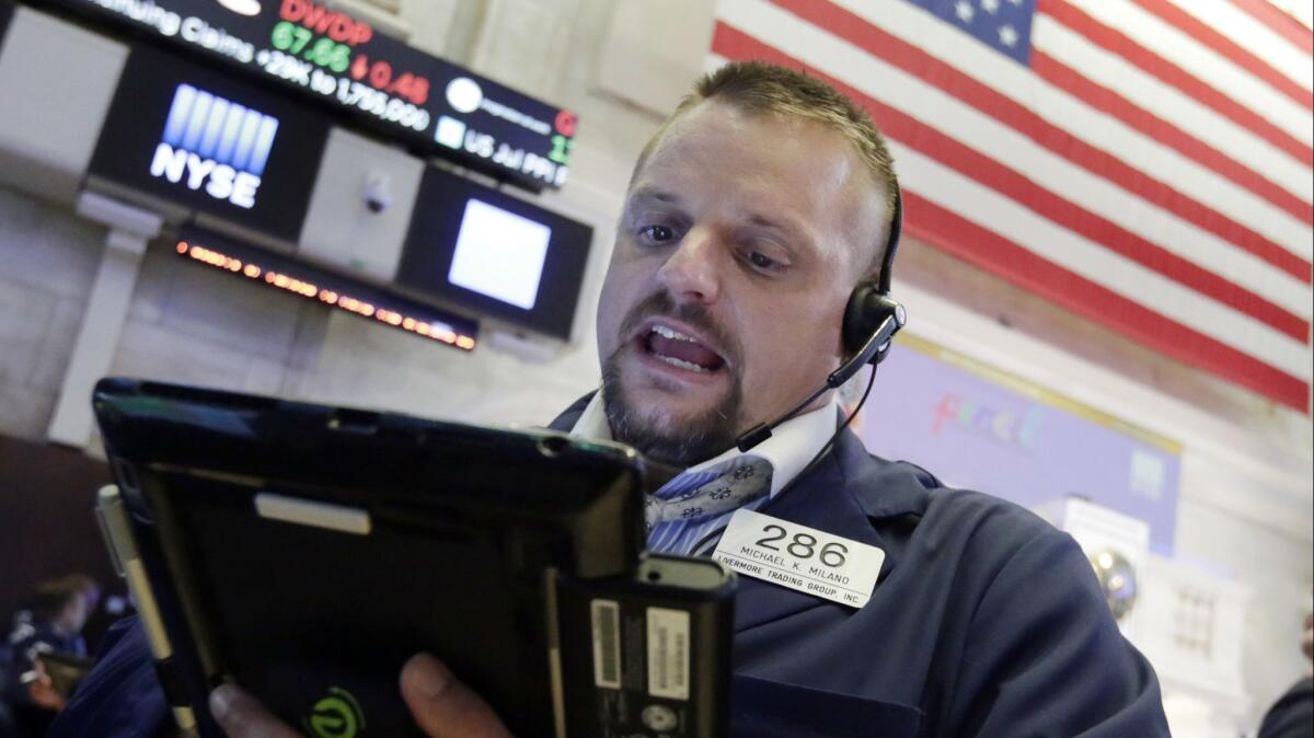 Trader Michael Milano works on the floor of the New York Stock Exchange.