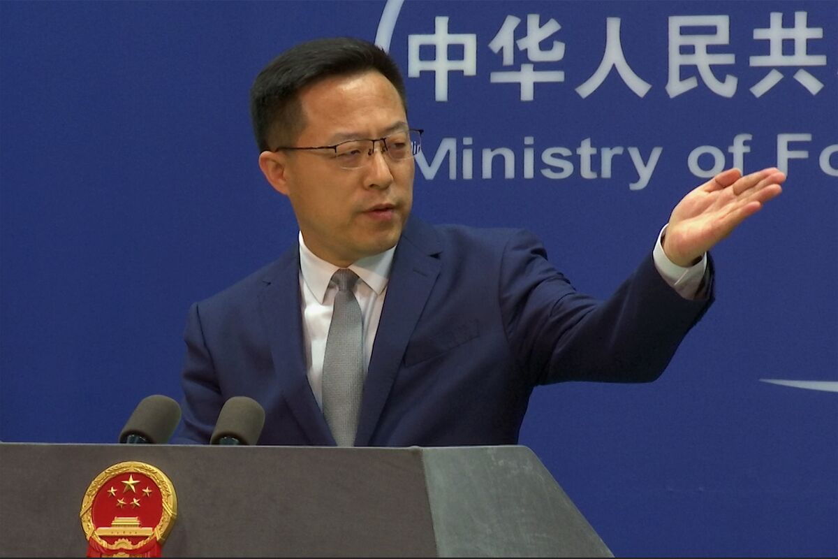 In this image made from video, Chinese Foreign Ministry spokesperson Zhao Lijian gestures during a media briefing at the Ministry of Foreign Affairs office, Wednesday, April 6, 2022, in Beijing. China on Wednesday said images of civilian deaths in the Ukrainian town of Bucha are "deeply disturbing" but that no blame should be apportioned until all facts are known. (AP Photo/Liu Zheng)