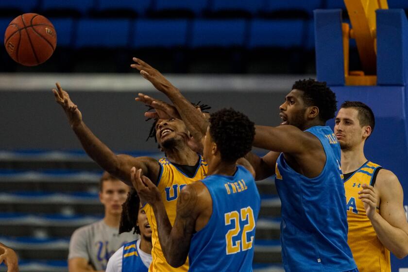 WESTWOOD, CALIF. - OCTOBER 23: Members of the Gold and Blue teams scramble to grab a loose ball as the UCLA Bruins hold a preseason showcase at Pauley Pavillion on Wednesday, Oct. 23, 2019 in Westwood, Calif. (Kent Nishimura / Los Angeles Times)