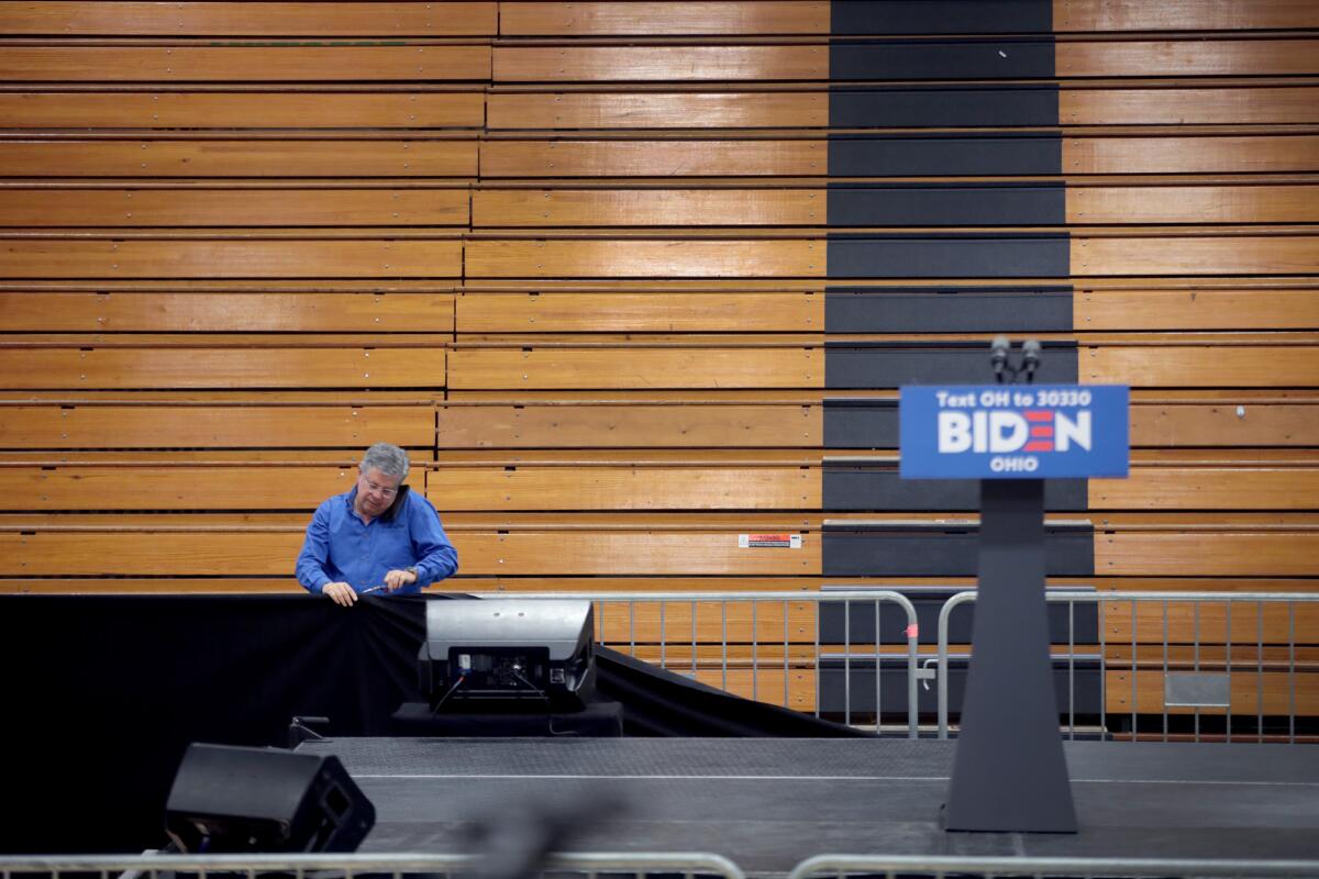 Workers tear down the setup for a canceled Joe Biden election-night rally in Cleveland on March 10.