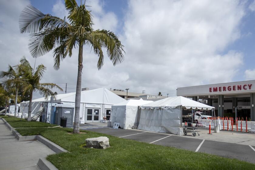A tent outside the emergency room of the Fountain Valley Regional Hospital & Medical Center is used to screen people for coronavirus symptoms before allowing them inside the hospital on Thursday, April 2.