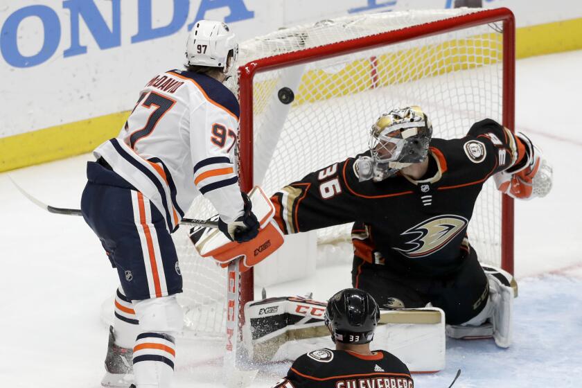 Oilers center Conor McDavid scores against Ducks goaltender John Gibson during the third period on Nov. 10 2019.