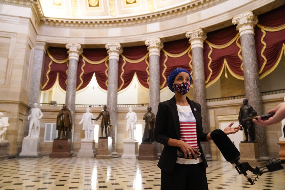 Rep. Ilhan Omar (D-Minn.) speaks with reporters inside the U.S. Capitol in 2021. 
