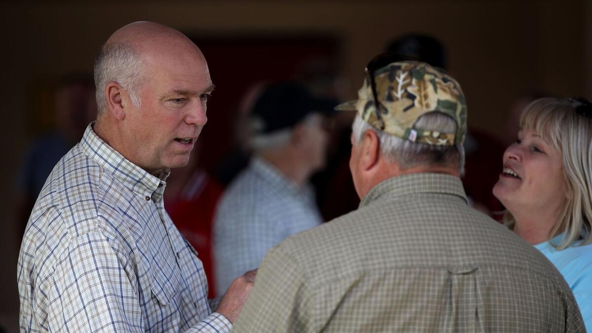 Republican congressional candidate Greg Gianforte, left, talks with supporters during a campaign meet and greet at Lions Park in Great Falls, Mont., on Tuesday.