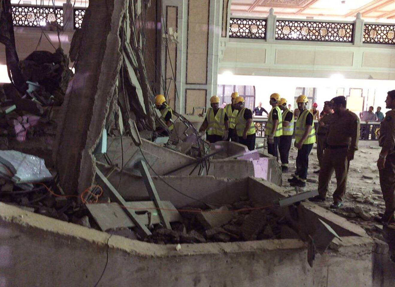 Civil Defense personnel inspect the damage at the Grand Mosque in Mecca after a crane collapsed, killing dozens of people Friday.