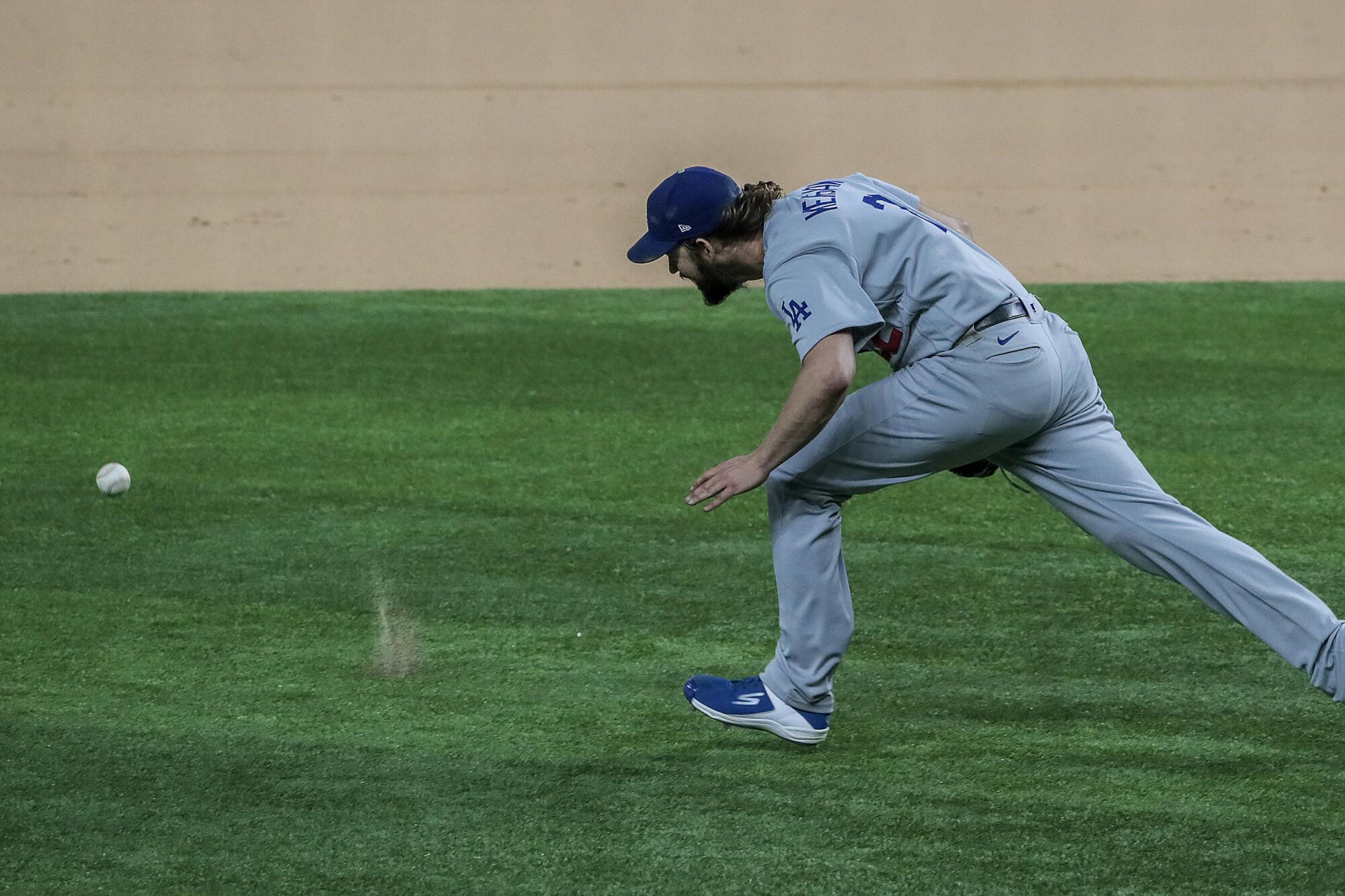 Dodgers starter Clayton Kershaw chases a grounder hit by Atlanta's Ronald Acuna Jr.