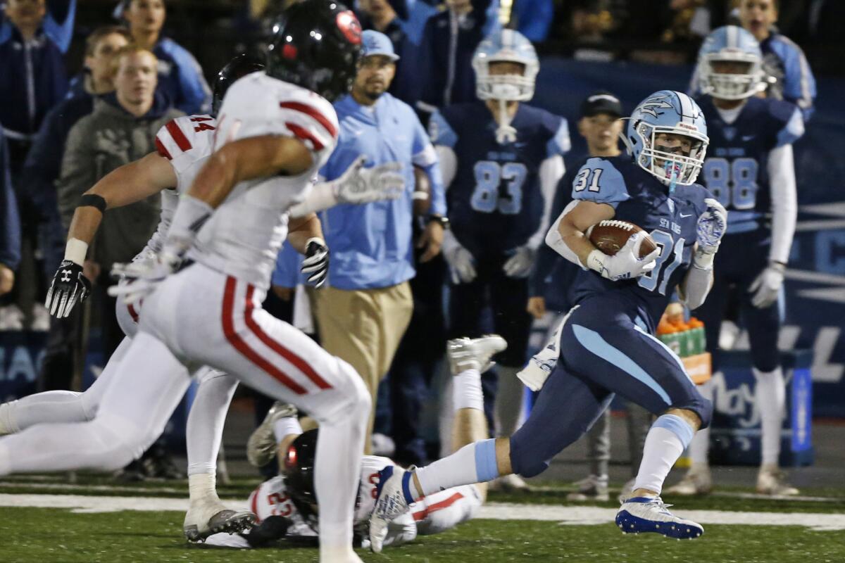 Corona del Mar’s Riley Binnquist runs for a 52-yard touchdown against Grace Brethren in the second quarter of the CIF Southern Section Division 3 title game on Nov. 29 at Newport Harbor High.