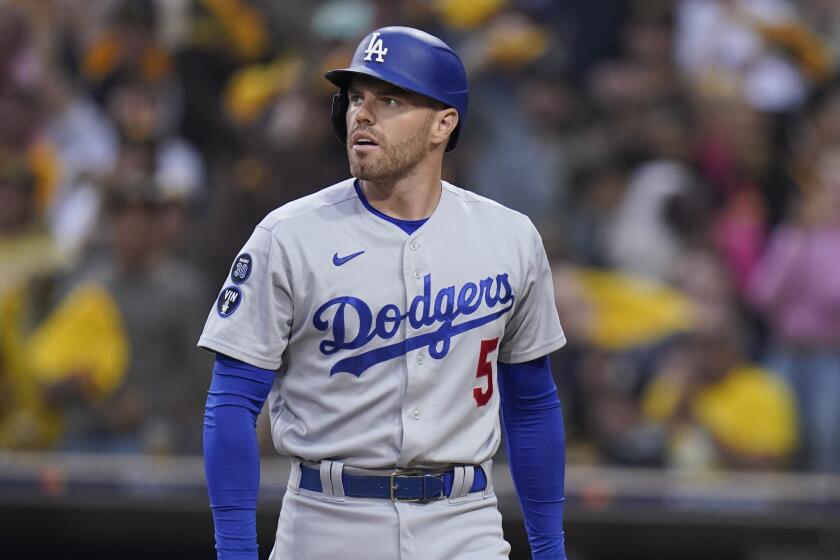 Los Angeles Dodgers' Freddie Freeman reacts after striking out during the first inning.