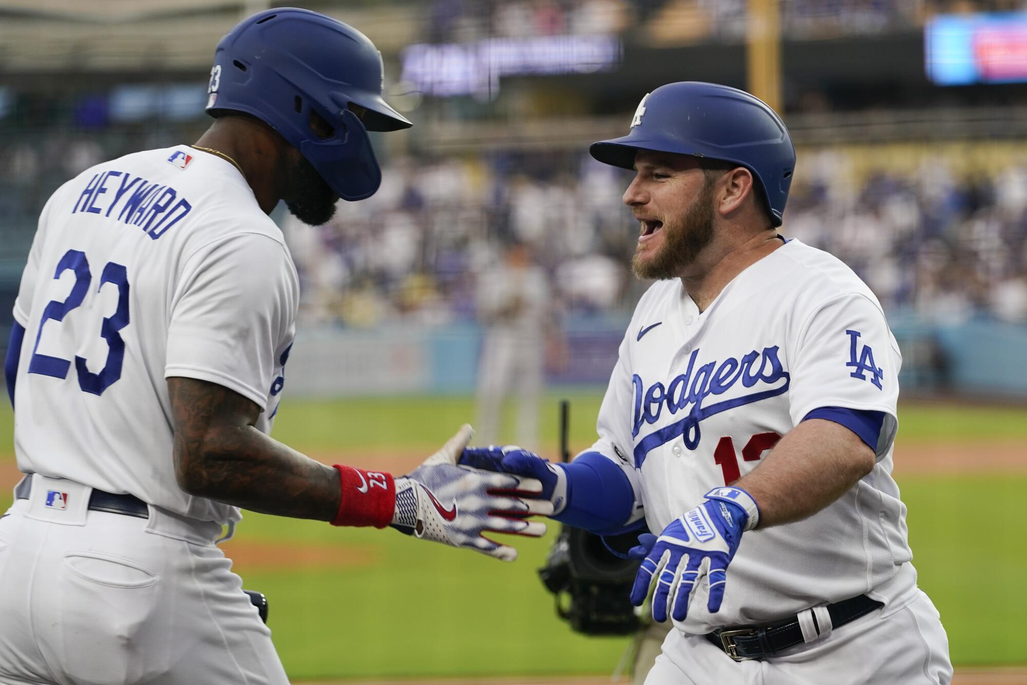Max Muncy is greeted by Jason Heyward after homering in the first inning. 