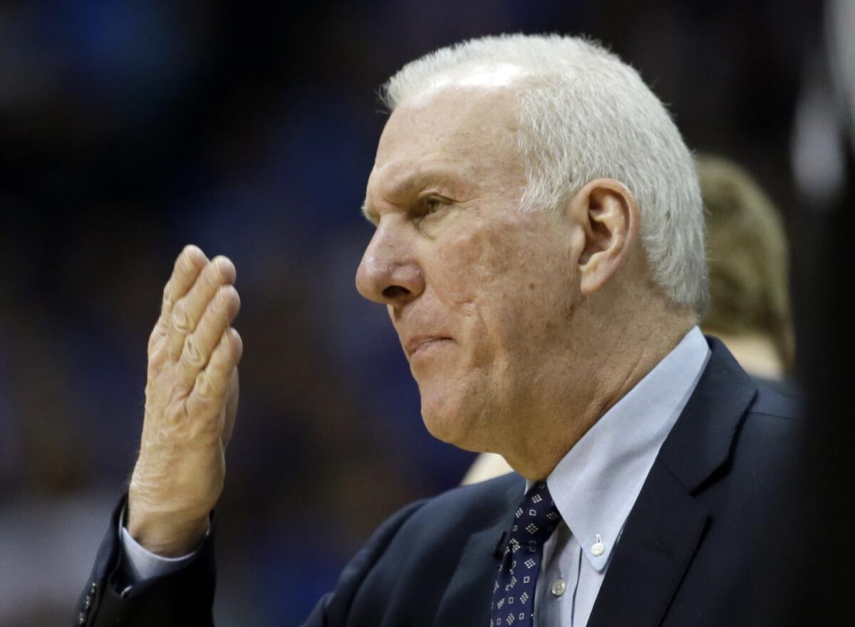 San Antonio Spurs Coach Gregg Popovich signals a play on Friday in Dallas.