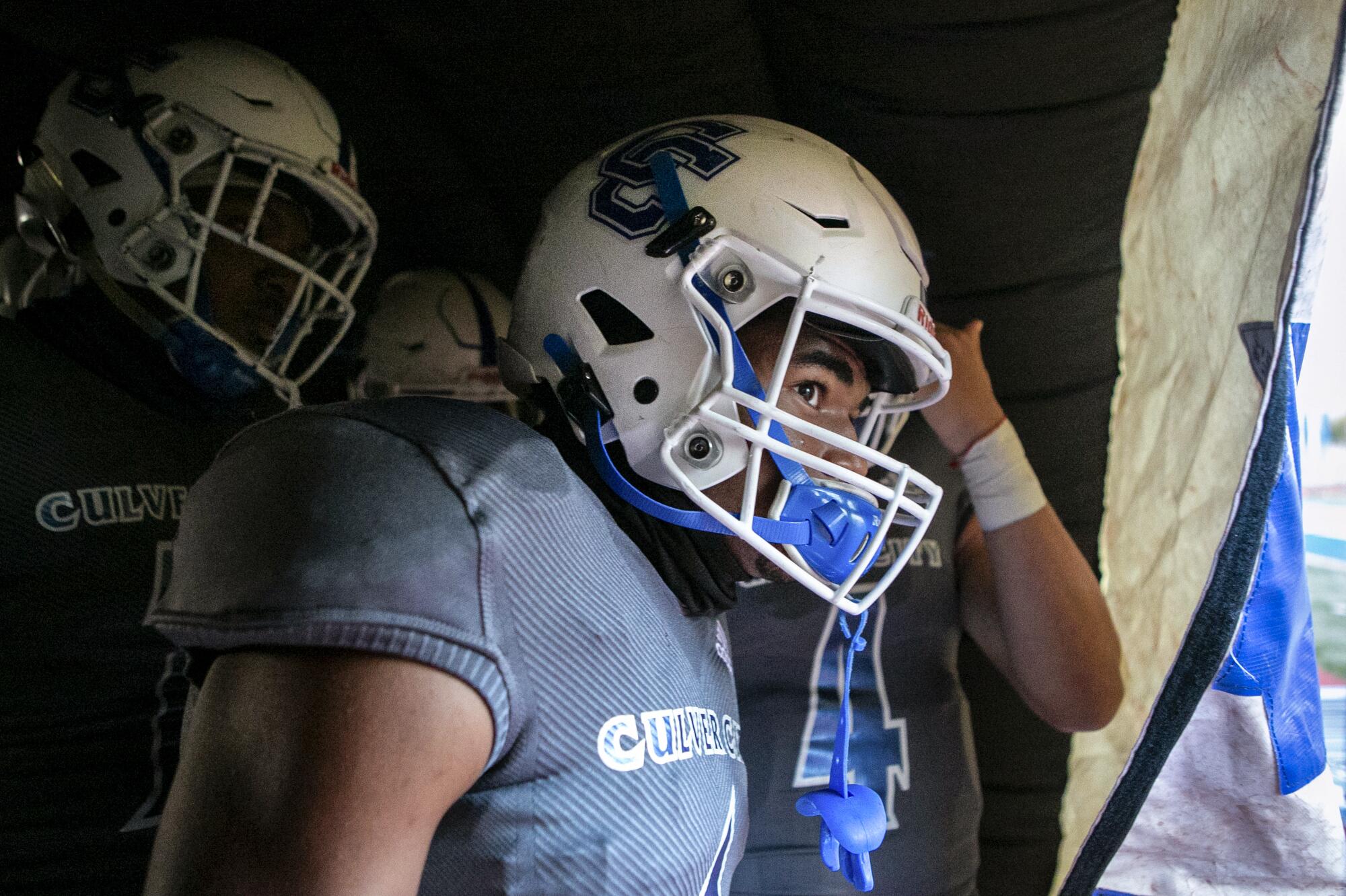 Ayinde Bankole (1) peaks his head out of the tunnel before the seniors are introduced at senior night.