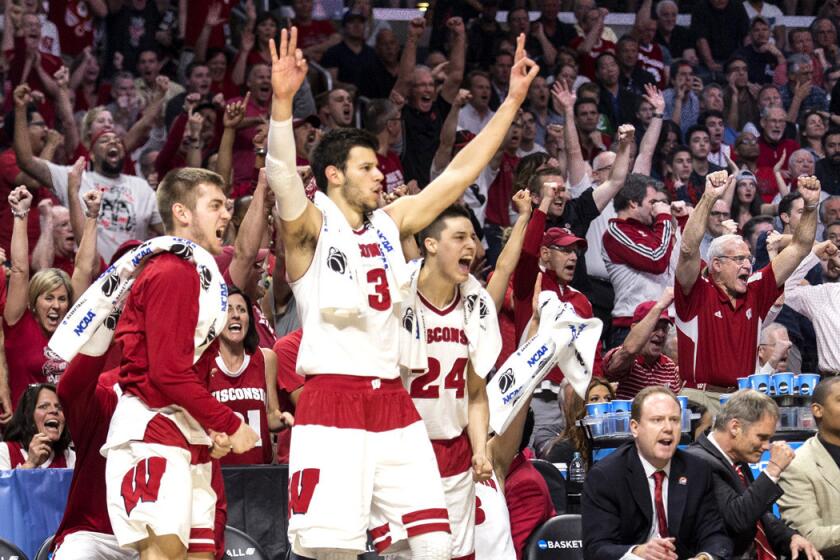 Wisconsin bench celebrates a three pointer during their, 79-72, win over North Carolina in the NCAA West Region semifinals at Staples Center on Thursday.