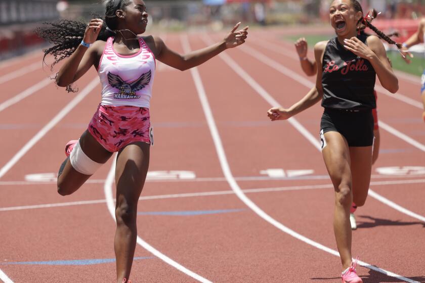 SAN DIEGO, CA - MAY 20, 2023: La Jolla's Payton Smith reacts to Madison's Amirah Shaheed, left, just edging out Smith at the finish line to win the girls 200 meter dash during the CIF-San Diego Section track finals at Mt. Carmel High School in San Diego on Saturday, May 20, 2023. (Hayne Palmour IV / For The San Diego Union-Tribune)
