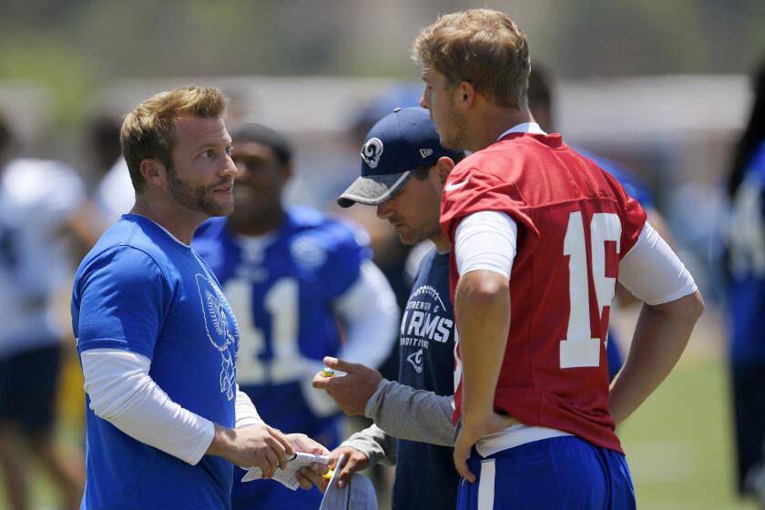 FILE - In this June 5, 2017, file photo, Los Angeles Rams coach Sean McVay, left, talks with quarterback Jared Goff, right, as offensive coordinator Matt LaFleur stands between them during NFL football practice in Thousand Oaks, Calif. Green Bay Packers coach LaFleur and Rams coach McVay say their friendship and shared history shouldn’t have much of an impact on their teams’ upcoming NFC divisional playoff matchup. (AP Photo/Mark J. Terrill, File)