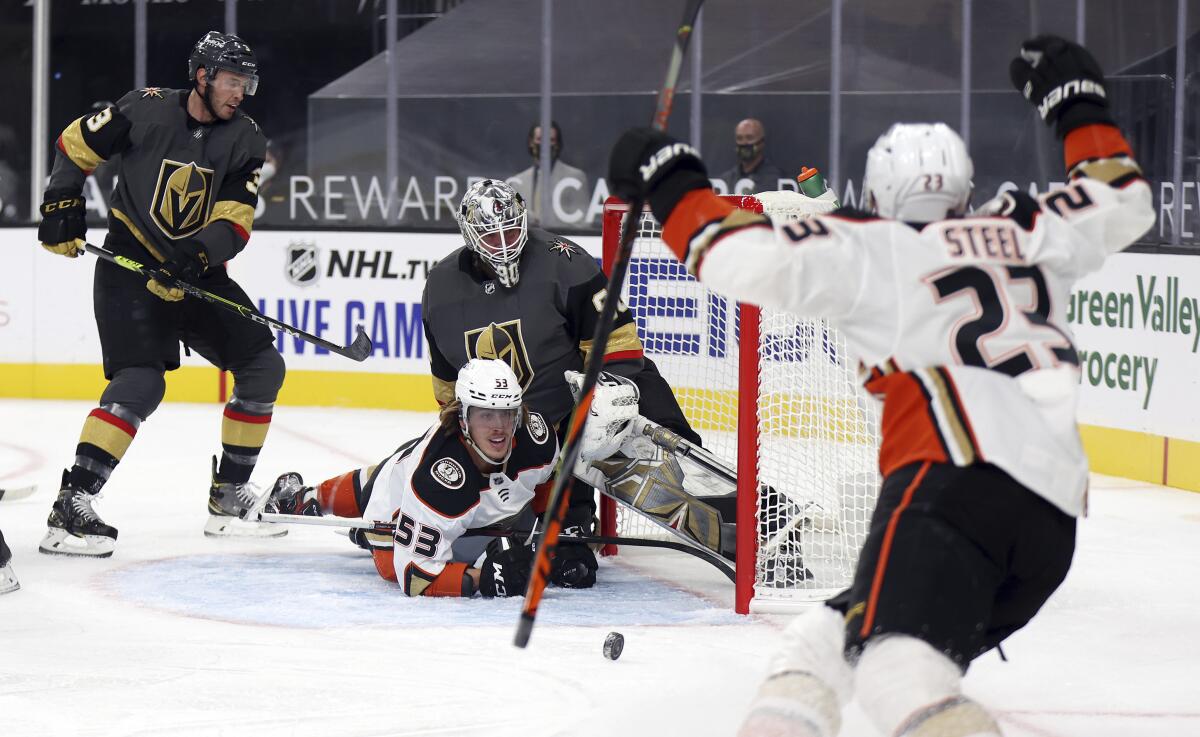 Ducks left wing Max Comtois looks up at center Sam Steel after scoring against the Vegas Golden Knights.
