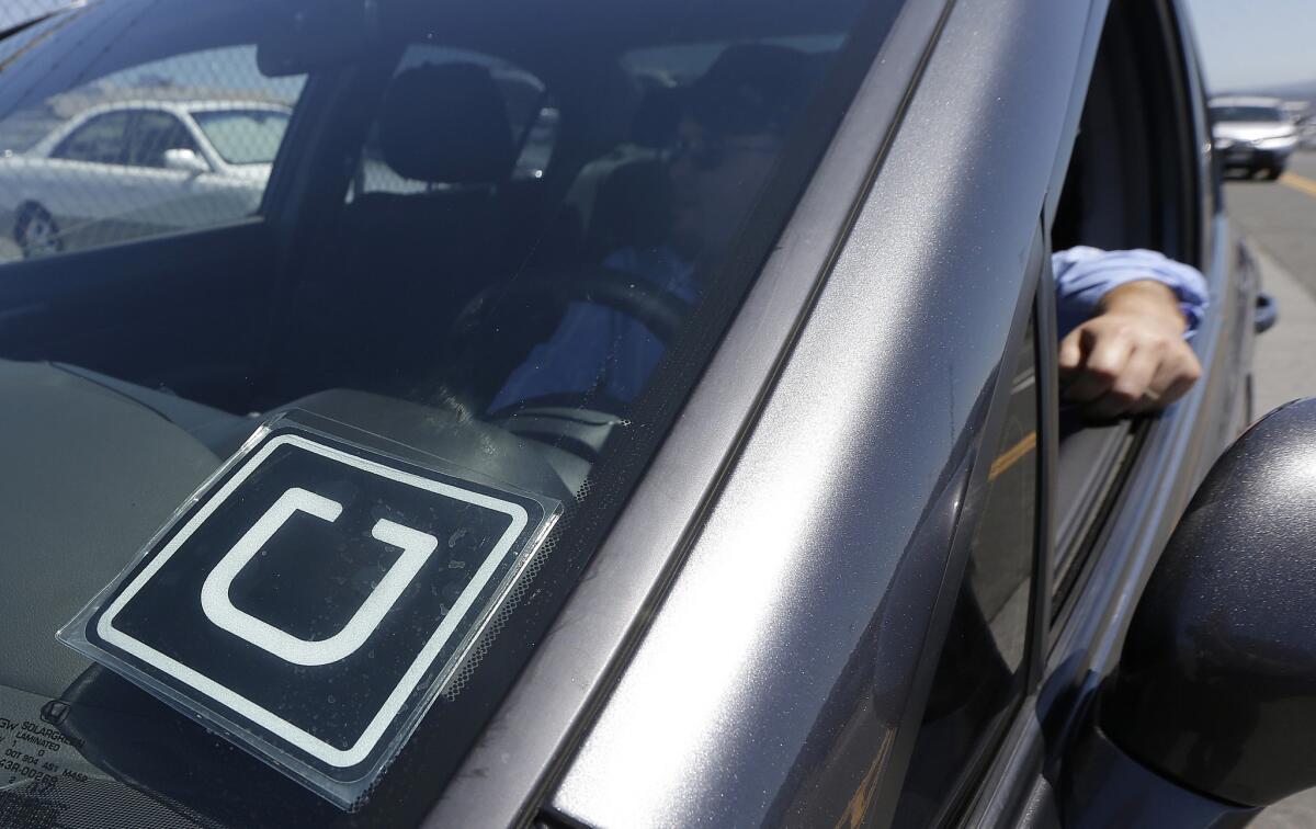 In July 2015, Uber driver Karim Amrani sits in his car parked near the San Francisco International Airport parking area.