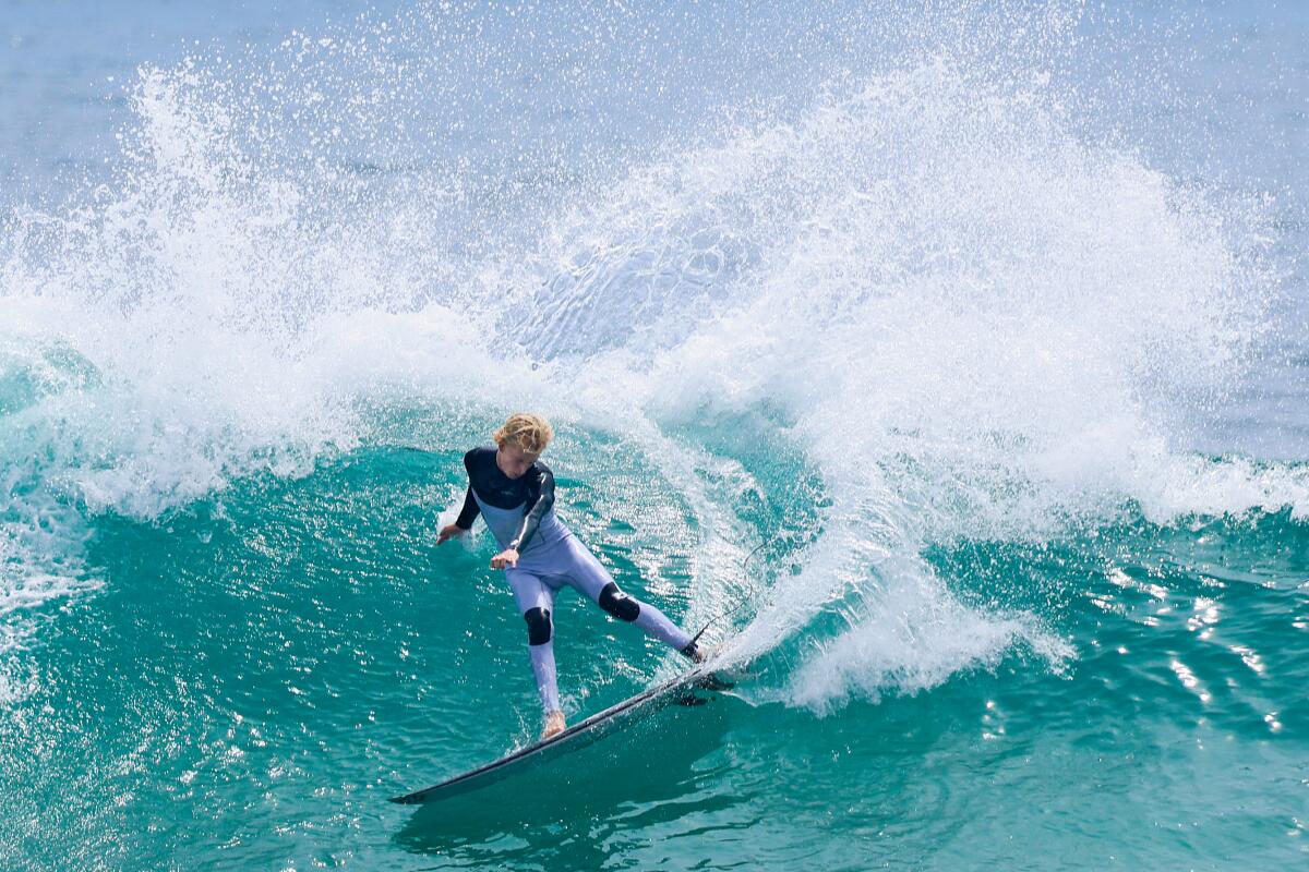     A surfer performs a sharp turn on a wave at Lower Trestles.