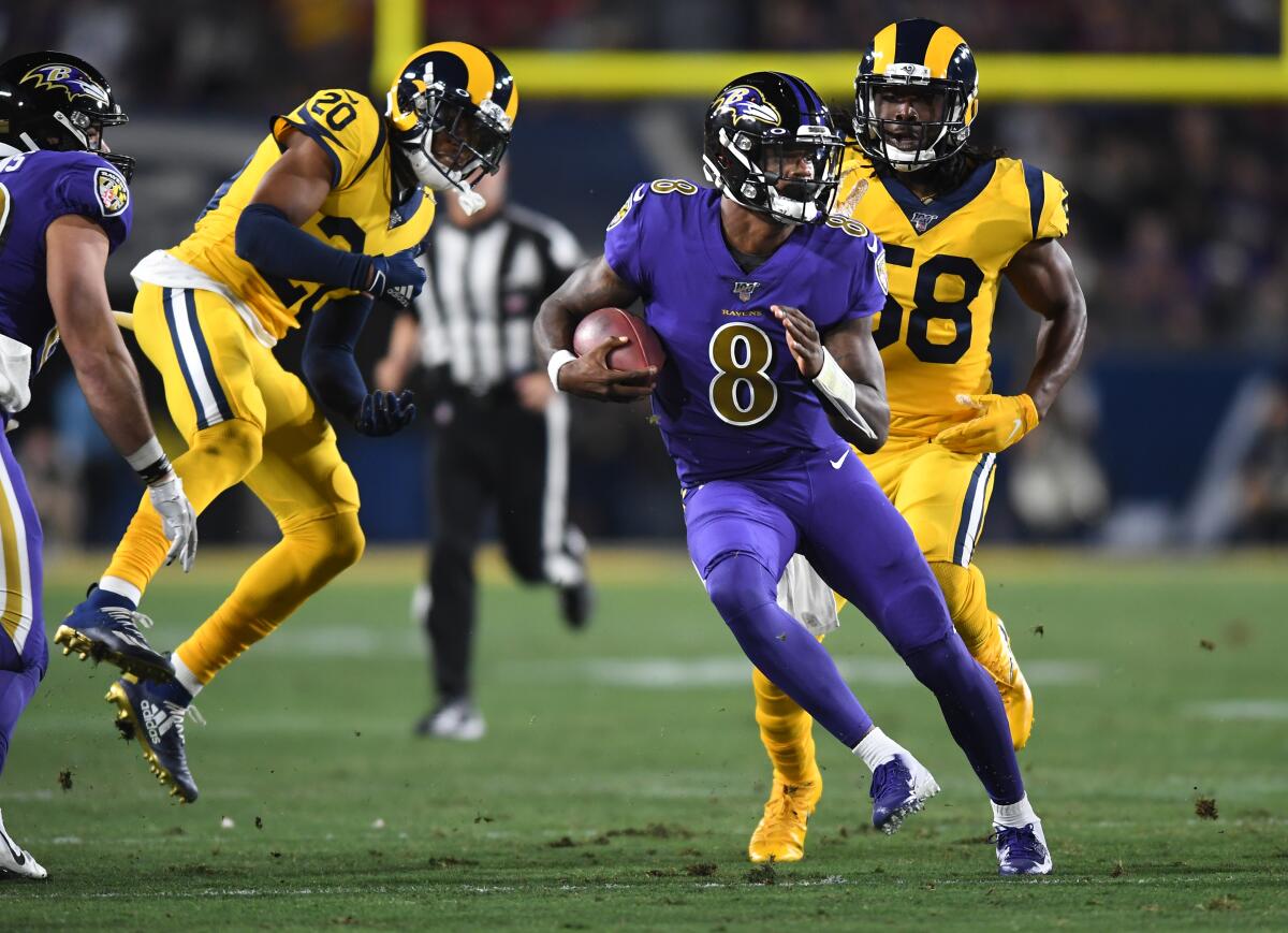 The Rams' defense could not keep up with Baltimore's Lamar Jackson (8).