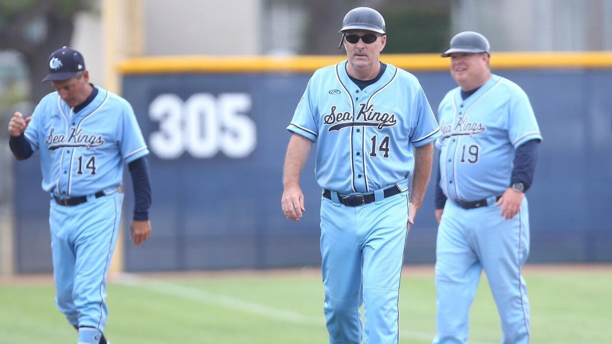 John Emme, middle, coaches his last Corona del Mar High baseball game on Tuesday. Emme won two CIF Southern Section titles, six league titles and 335 games during his 21 years at the helm of the Sea Kings.