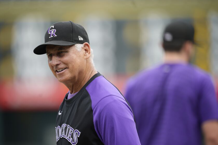 Colorado Rockies manager Bud Black jokes with players from the Los Angeles Dodgers before a baseball game Thursday, July 28, 2022, in Denver. (AP Photo/David Zalubowski)