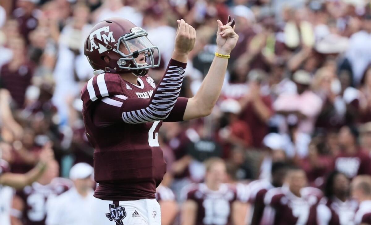 Johnny Manziel gives the "money" sign during a game against Rice.