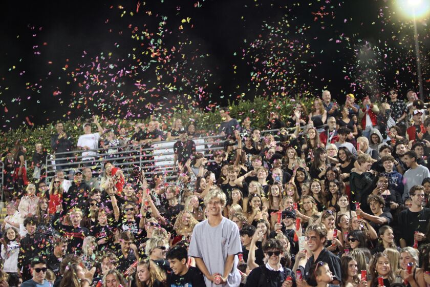Current La Jolla High students celebrate the school's centennial with confetti at the homecoming football game Sept. 30.