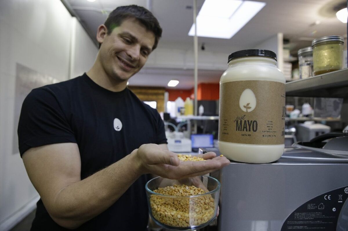 Chief Executive Josh Tetrick holds a species of yellow pea used to make Just Mayo, a plant-based mayonnaise, at Hampton Creek Foods in San Francisco.