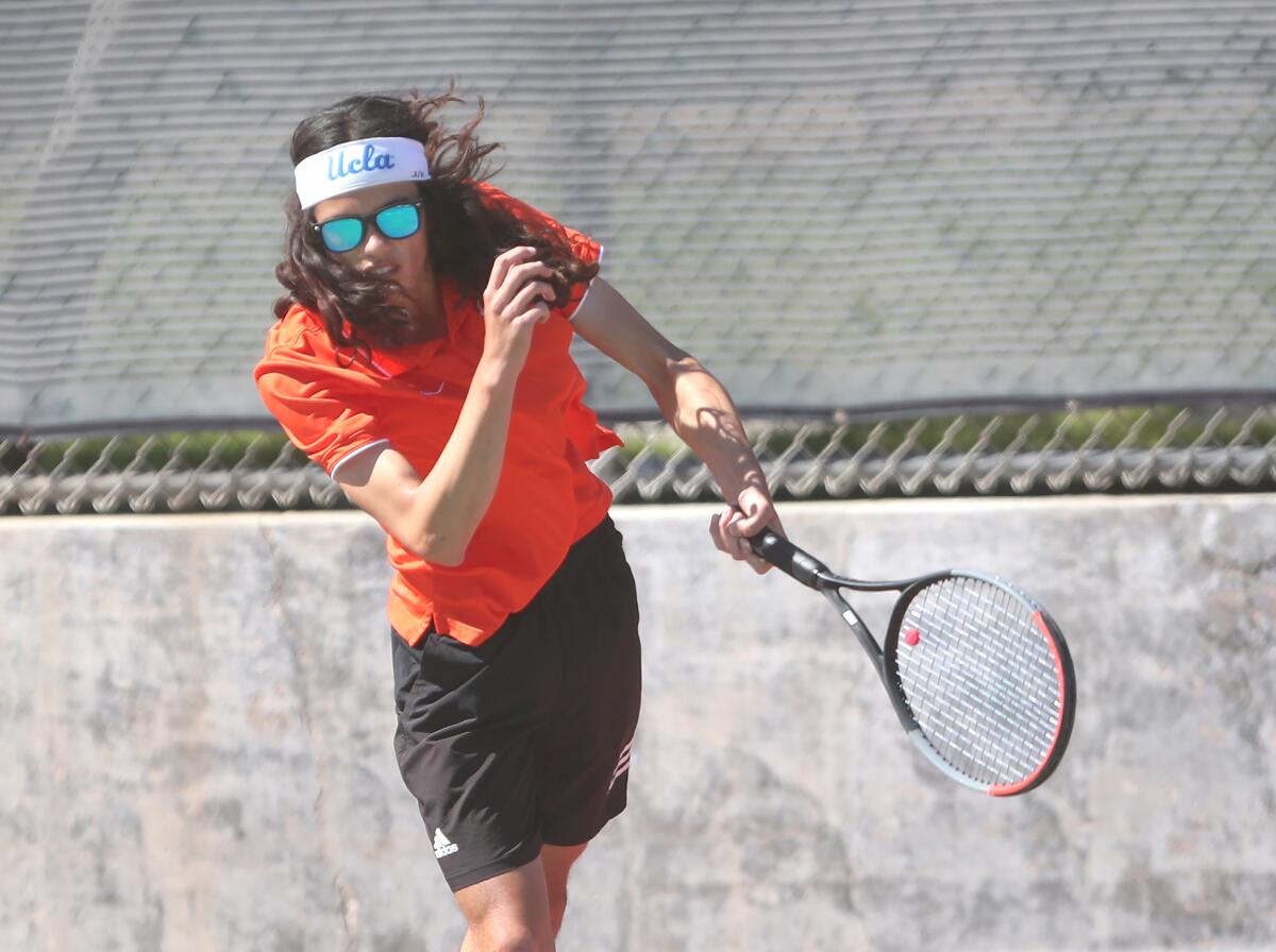 Parker Kuo of Huntington Beach competes in a doubles match against Newport Harbor on Tuesday.