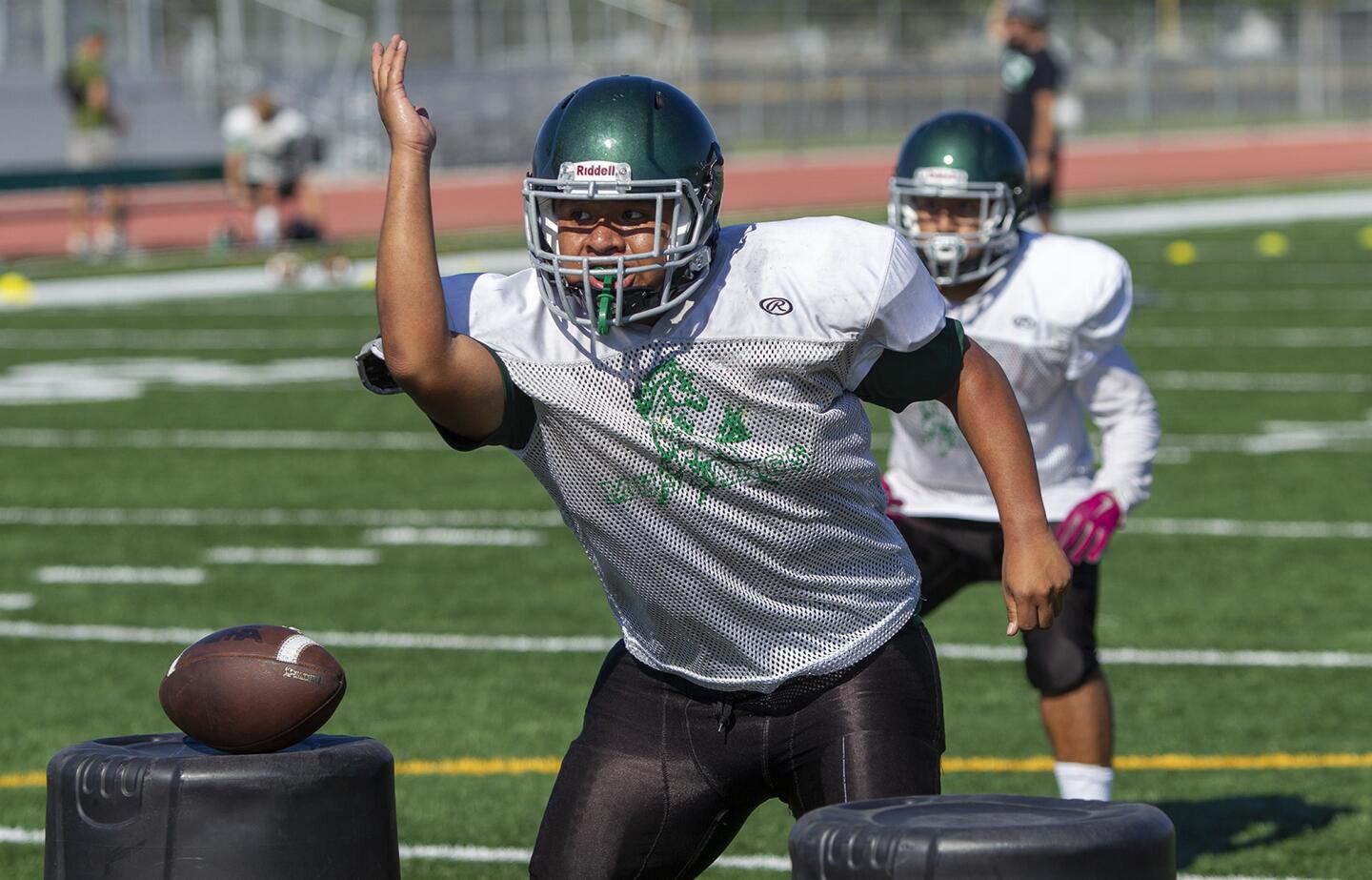 Costa Mesa's Carlos Aguilar works on line drills during practice on Tuesdasy, August 14.