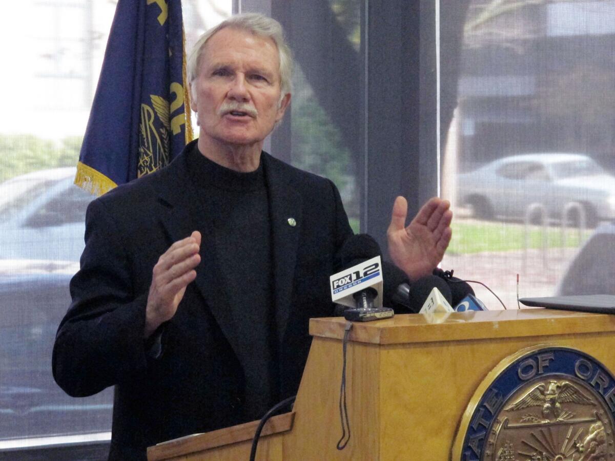 In this file photo, Oregon Gov. John Kitzhaber discusses problems with the website for Cover Oregon, the state's health insurance exchange, during a news conference in Portland.