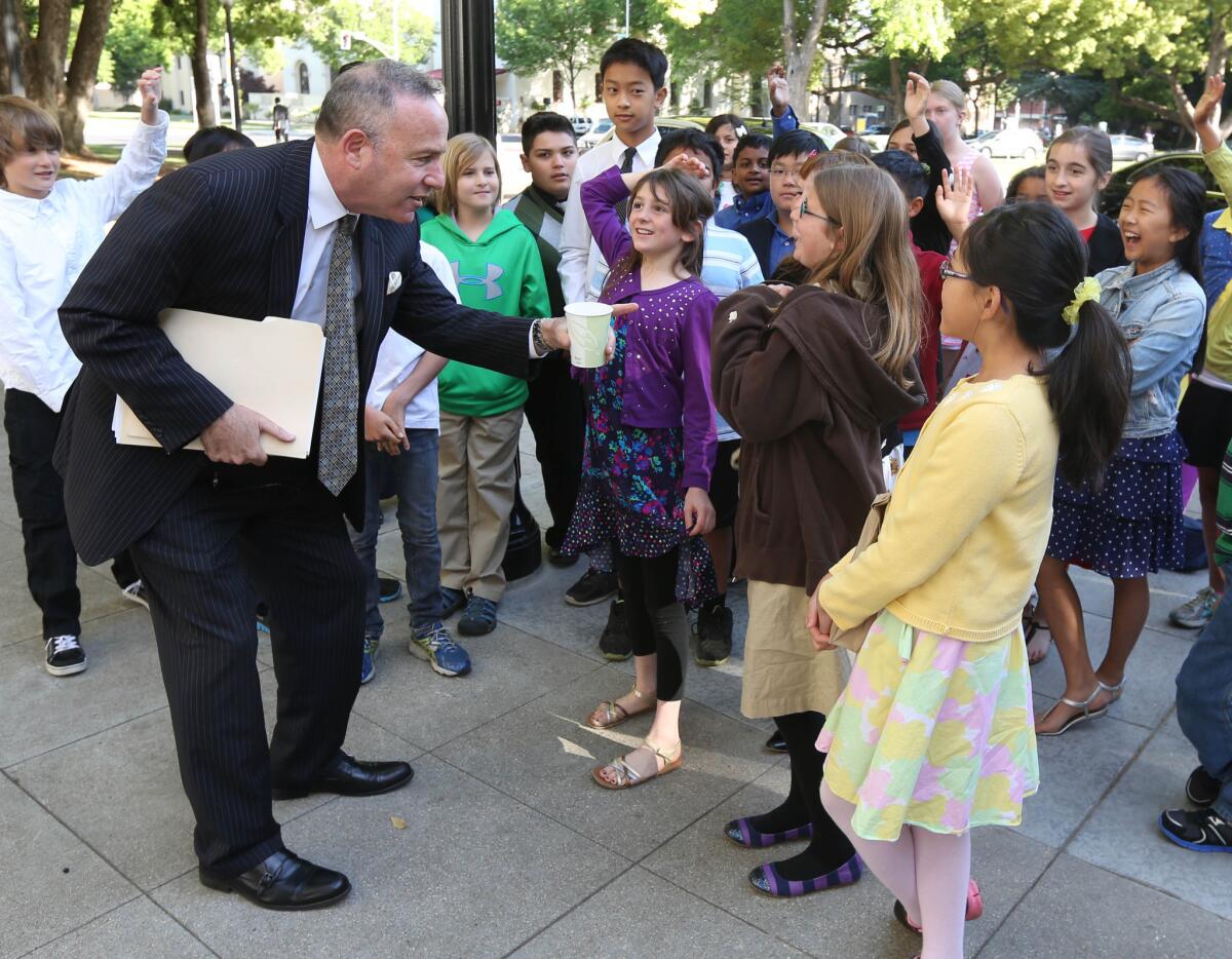 Senate leader Darrell Steinberg (D-Sacramento) speaks to schoolchildren while heading to a meeting about ethics with other senators.