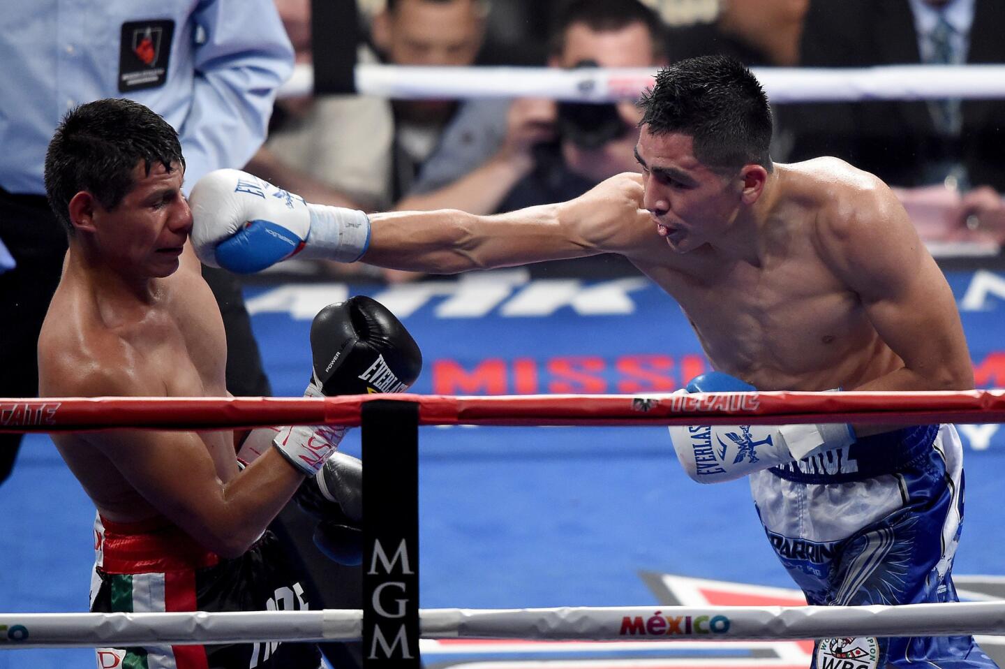 Leo Santa Cruz, right, throws a right at Jose Cayetano during their featherweight bout Saturday in Las Vegas.
