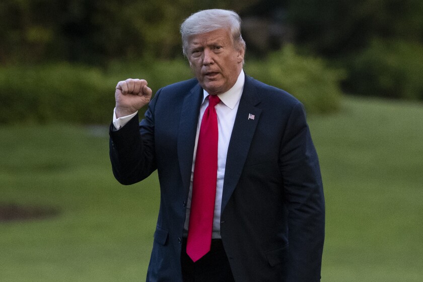 President Donald Trump pumps his fist as he walks on the South Lawn after arriving on Marine One at the White House, Thursday, June 25, 2020, in Washington. Trump is returning from Wisconsin. (AP Photo/Alex Brandon)