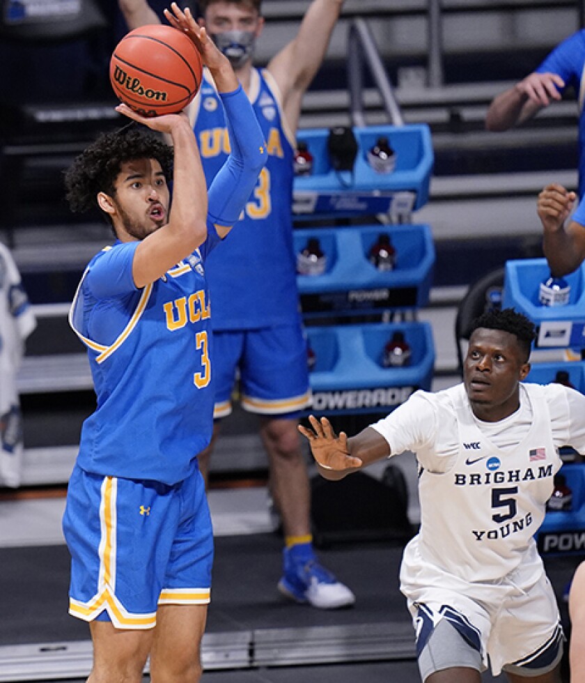 UCLA's Johnny Juzang shoots a three-pointer.