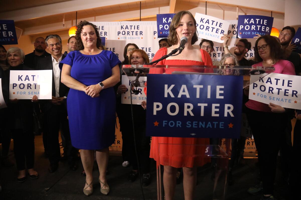 U.S. Representative Katie Porter applauds her daughter Betsy Hoffman, 12.
