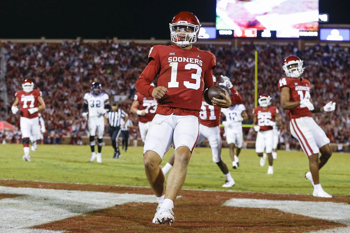 Oklahoma quarterback Caleb Williams (13) runs in for a touchdown during the second half of an NCAA college football game against TCU, Saturday, Oct. 16, 2021, in Norman, Okla. (AP Photo/Alonzo Adams)