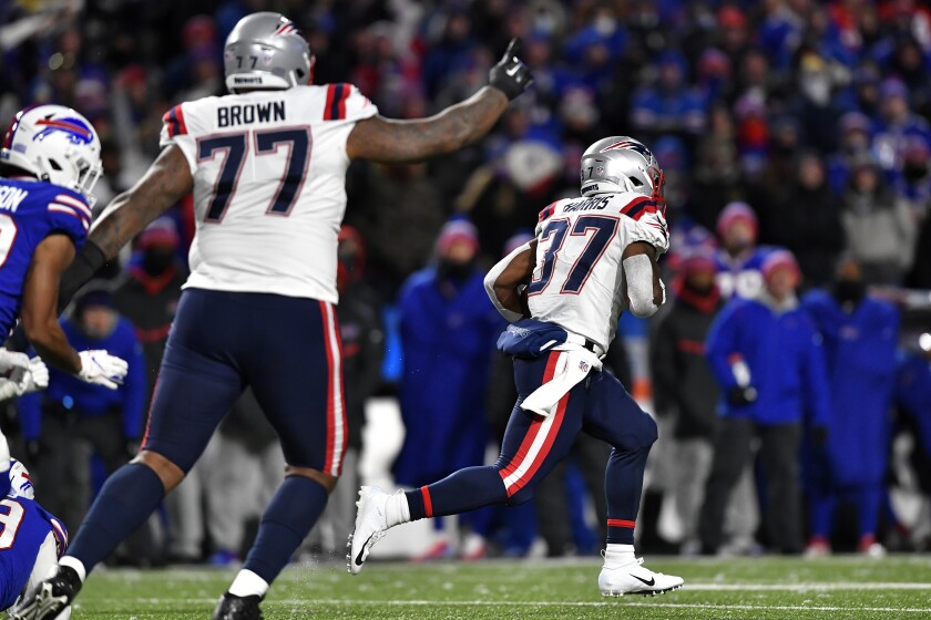 New England Patriots running back Damien Harris (37) takes a handoff for a touchdown during the first half of an NFL football game against the Buffalo Bills in Orchard Park, N.Y., Monday, Dec. 6, 2021. (AP Photo/Adrian Kraus)