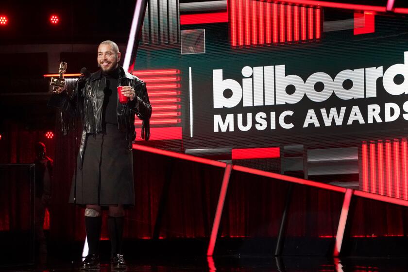 HOLLYWOOD, CA - OCTOBER 14, 2020: Post Malone accepts the Top Artist award during the 2020 Billboard Music Awards held at the Dolby Theatre in Hollywood, CA. (Andrew Gombert / Los Angeles Times)