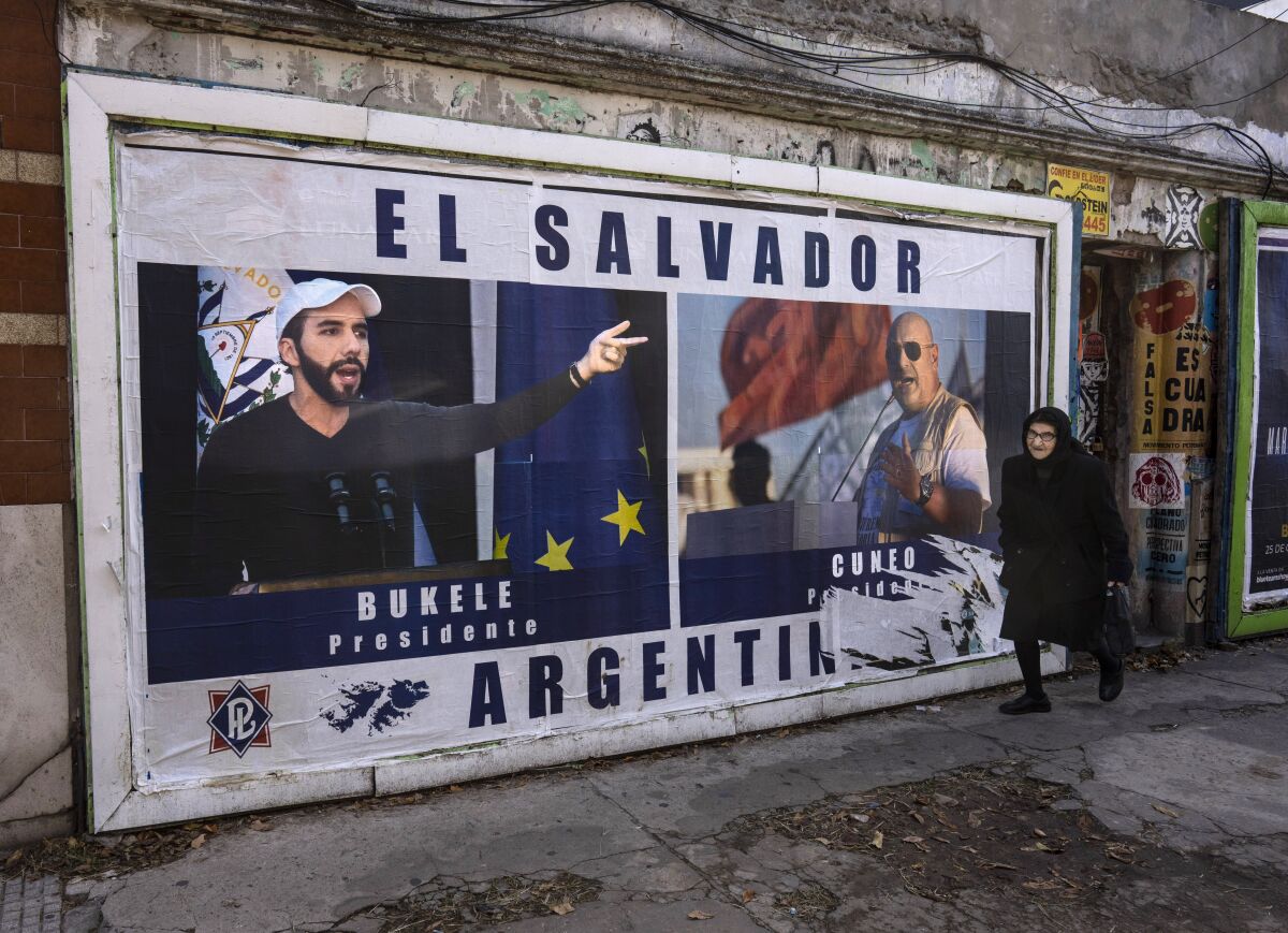A woman walks past a billboard promoting Labor Party presidential candidate Santiago Cuneo, alongside an image of El Salvador's President Nayib Bukele, in Buenos Aires, Argentina, Tuesday, May 9, 2023. Cuneo says he seeks to emulate Bukele's model of government. General elections are scheduled to be held in Argentina on Oct. 22. (AP Photo/Rodrigo Abd)