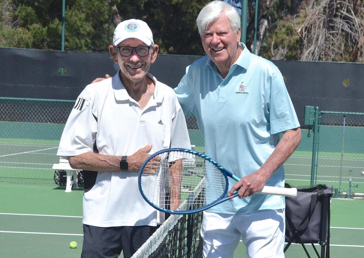 Good friends Bob Braun and Larry Collins, from left, play tennis at the Palisades Tennis Club in Newport Beach on Monday.