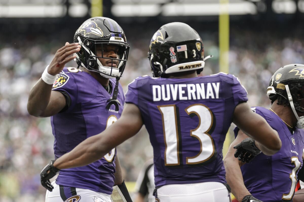 Baltimore Ravens quarterback Lamar Jackson, left, celebrates with Devin Duvernay after they connected for a touchdown during the second half of an NFL football game against the New York Jets, Sunday, Sept. 11, 2022, in East Rutherford, N.J. (AP Photo/Adam Hunger)