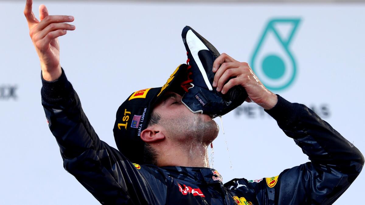 Formula One driver Daniel Ricciardo celebrates on the podium after winning the Malaysian Grand Prix on Sunday.