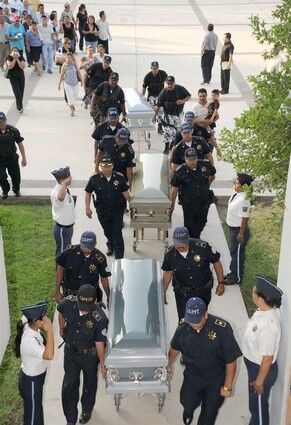 Members of the Police of Sinaloa, carry on June 27, 2008 the coffins of three policemen killed on Thursday in Culiacan, Sinaloa State. The officers were killed by an armed commando while they were on patrol.